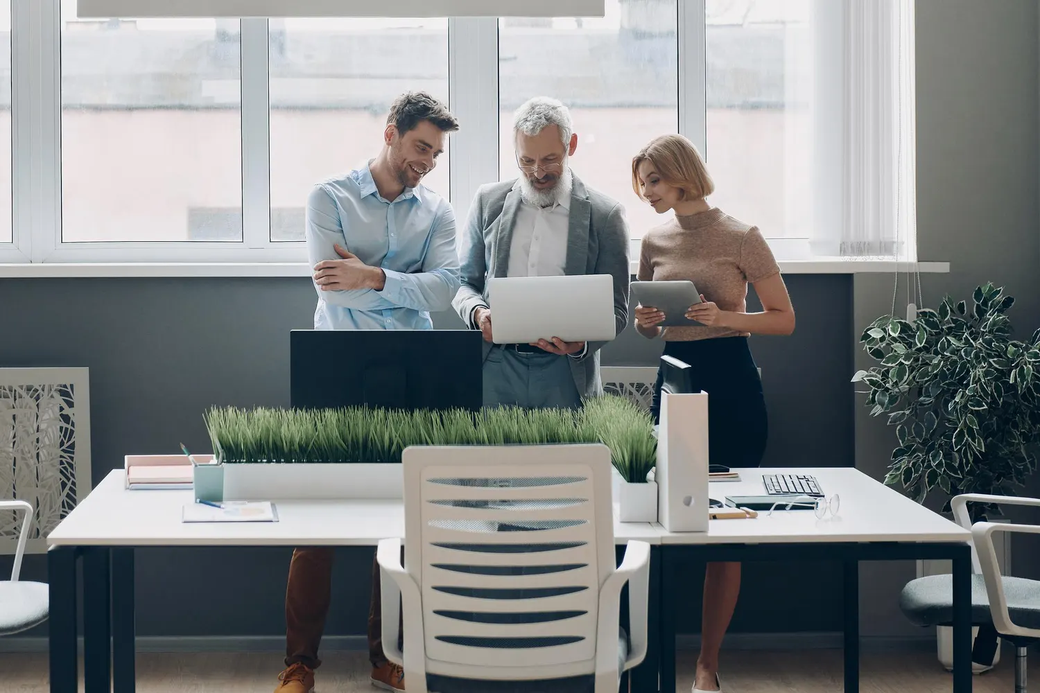 Two colleagues reviewing LEI transfers on a laptop